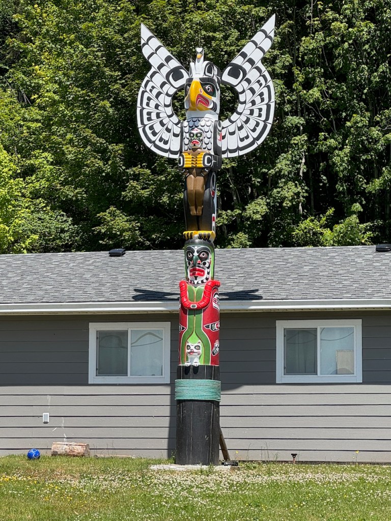 Totem in front of home in Alert Bay.